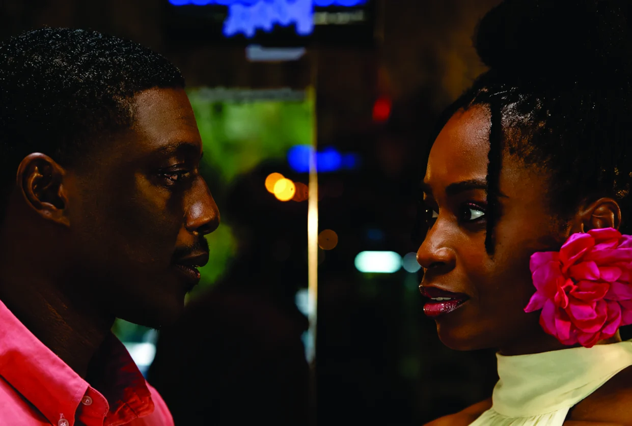 Film still — Eli and Soluchi face to face under city lights