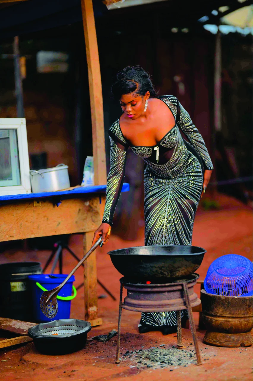Chiamaka at her akara stand in a beaded gown