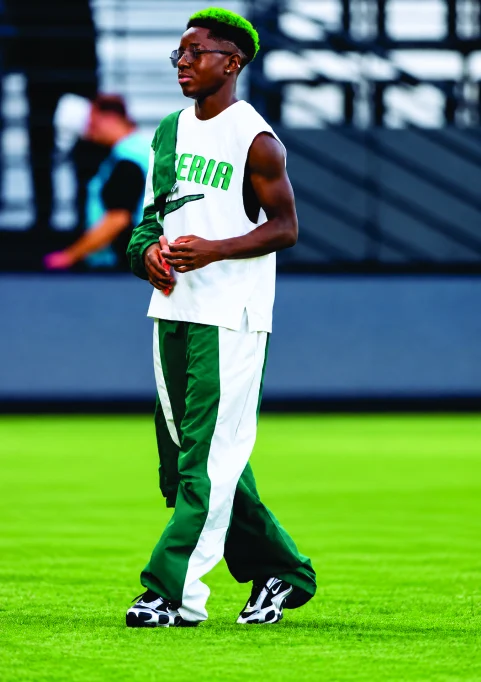 A Super Falcon with bright green hair in a white and green kit