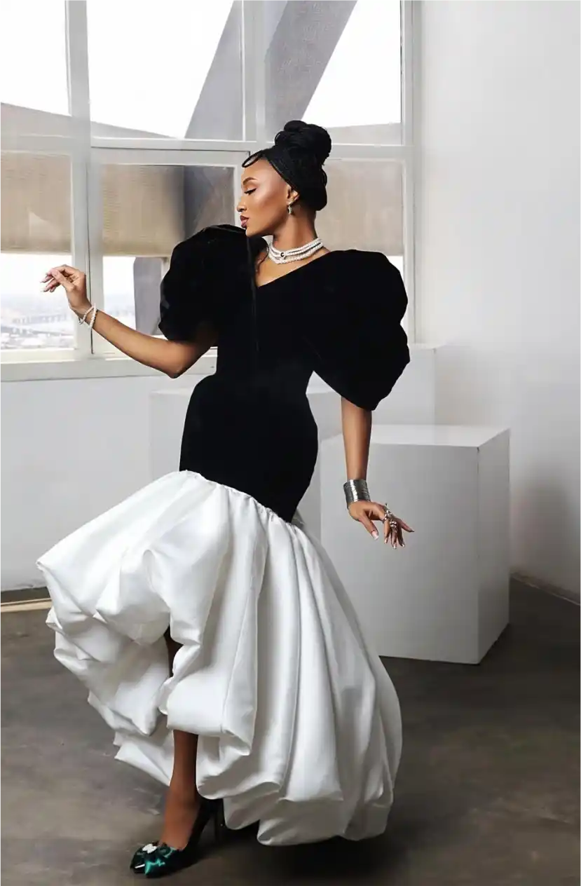 Woman in dramatic black bodice and white billowing ball gown skirt
