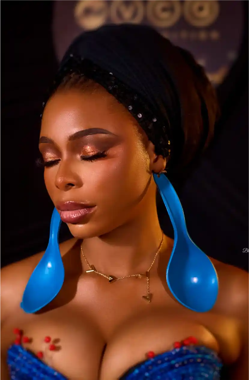 Close-up portrait of woman in striking blue earrings and accessories