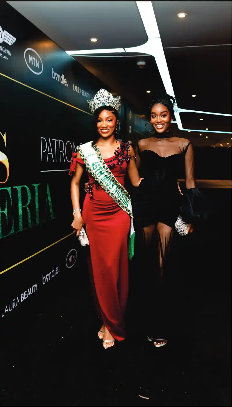 Miss Nigeria in red dress with friend in black