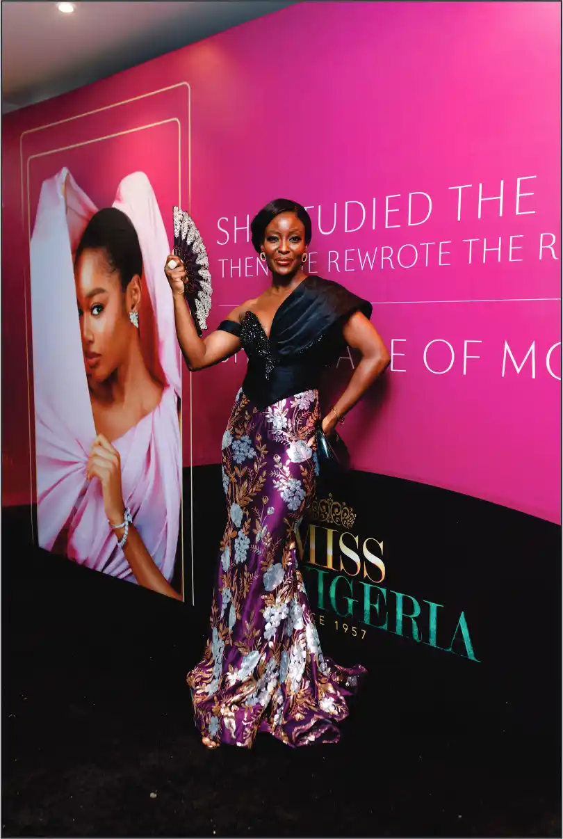 Woman with tiara near Miss Nigeria banner