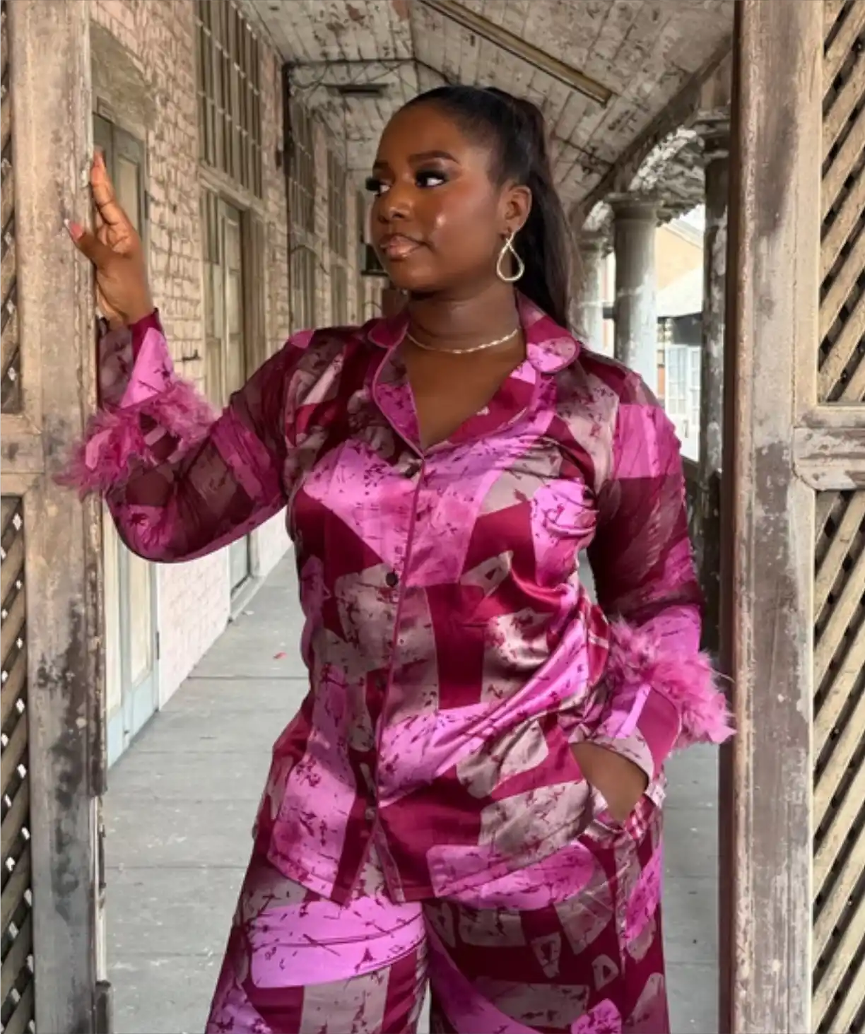 Woman in purple and white adiré oversized shirt and shorts