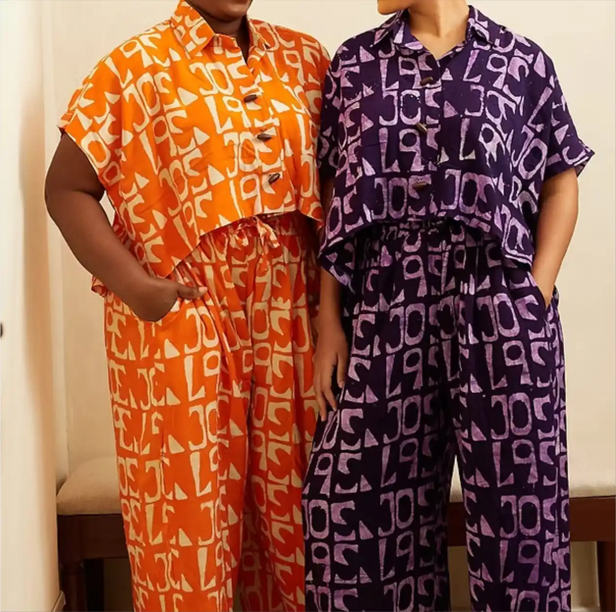 Two models in orange and purple Jola-print coordinated sets