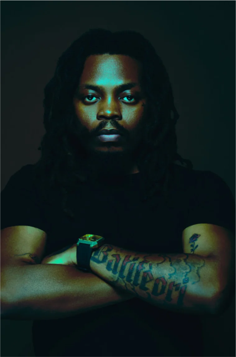 Bhadboi OML with dreadlocks in a dark moody portrait