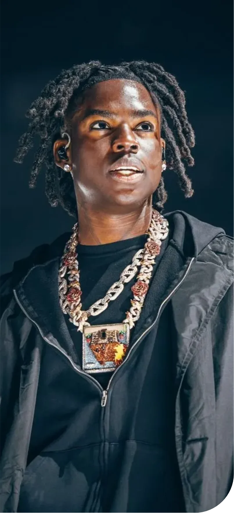 Portable wearing ornate chains on stage