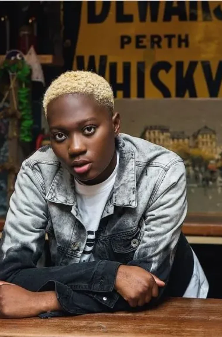 Zinoleesky with short blonde hair in a denim jacket
